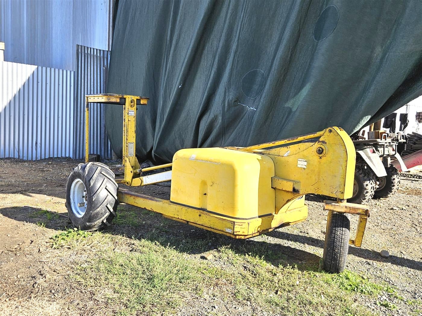 Yellow single-operator orchard bin lifter with front forks